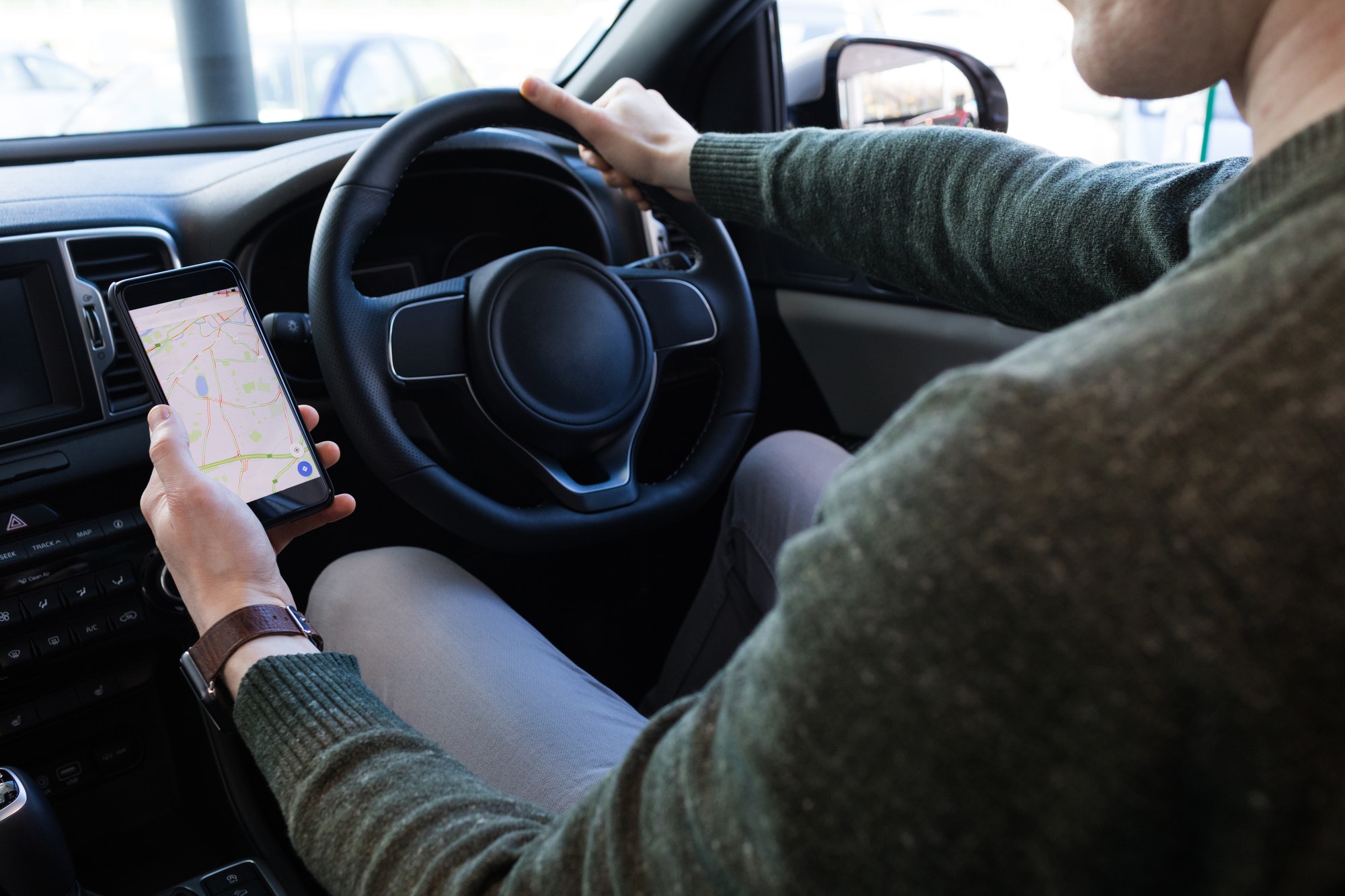 man-using-smartphone-while-driving-car.jpg